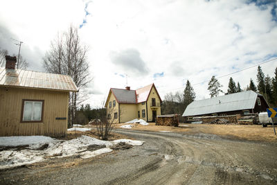 Houses against sky during winter