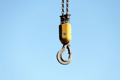 Low angle view of hanging against blue sky