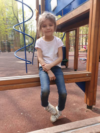 Portrait of a smiling girl sitting outdoors