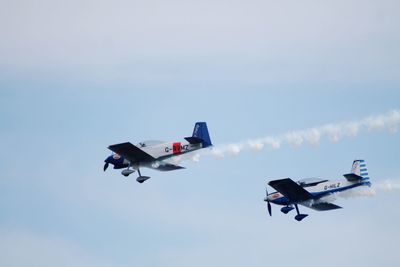 Low angle view of airplane flying against sky