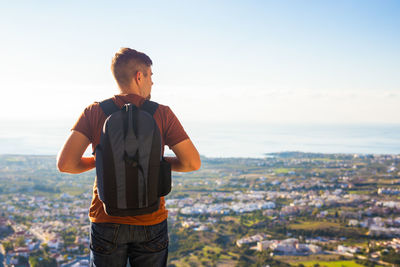 Man standing on city against sky