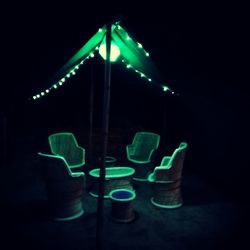 Illuminated table against black background