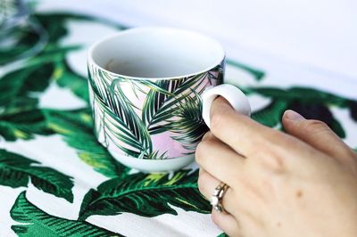 Close-up of hand holding coffee cup