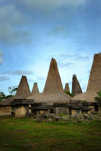 Built structure on field against sky