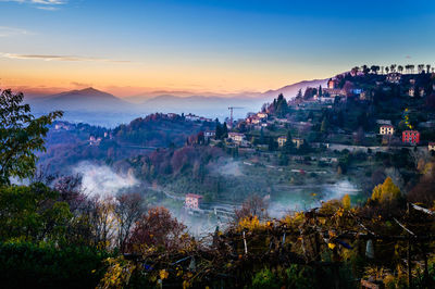 Panoramic view of cityscape against sky during sunset