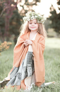 Portrait of girl wearing wreath at park