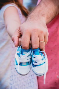 Low section of child holding hands