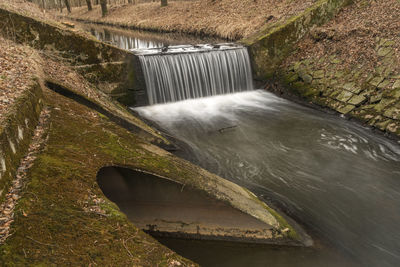 High angle view of water flowing in dam