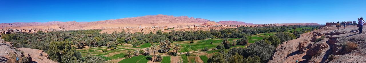 Panoramic view of landscape against blue sky