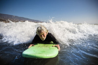 Man splashing water in sea