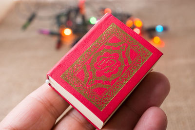 Close-up of hand koran at table