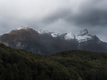 Scenic view of mountains against cloudy sky