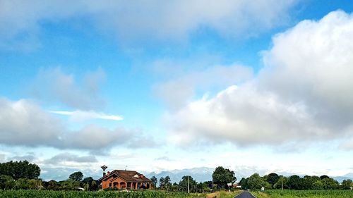 Panoramic view of building and trees against sky