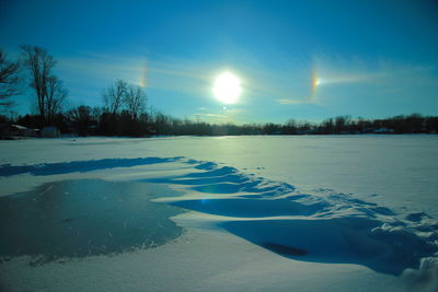 Scenic view of frozen landscape against sky at night