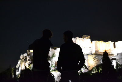 Men on silhouette people against sky at night