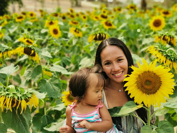 Portrait of mother and daughter on sunflower