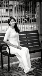 Portrait of young woman sitting on seat