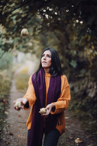 Young woman looking at camera in forest