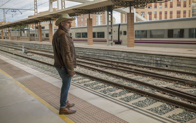 Portrait of adult man on cowboy hat waiting in train station. almeria, spain