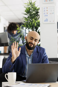 Young woman using laptop at office