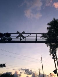 Low angle view of power lines against sky