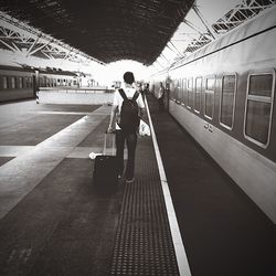 Full length of woman standing by railing