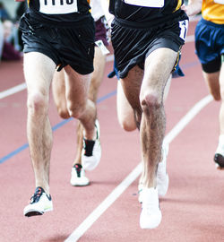 Low section of two people running