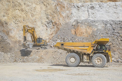 Loader loading mining truck at open pit
