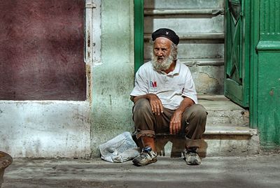 Portrait of man sitting outdoors