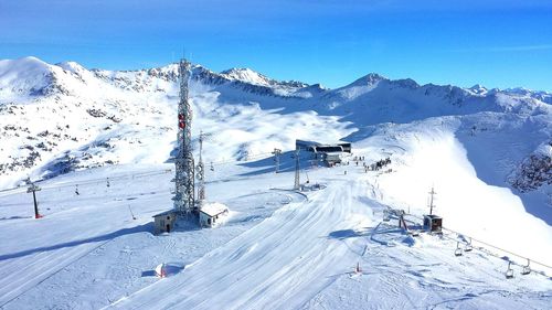 Electric pylon on snow field