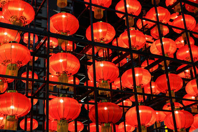 Low angle view of illuminated lanterns hanging at night