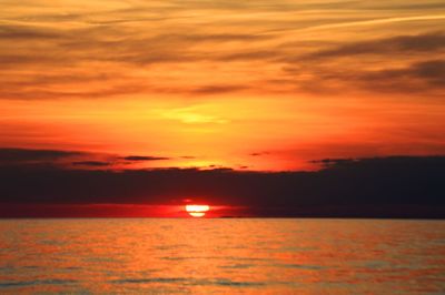 Scenic view of sea against romantic sky at sunset