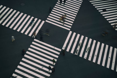 Blurred motion of people walking on road