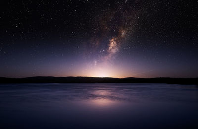 Scenic view of lake against star field at night