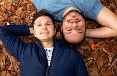 High angle view of gay men lying on field at park