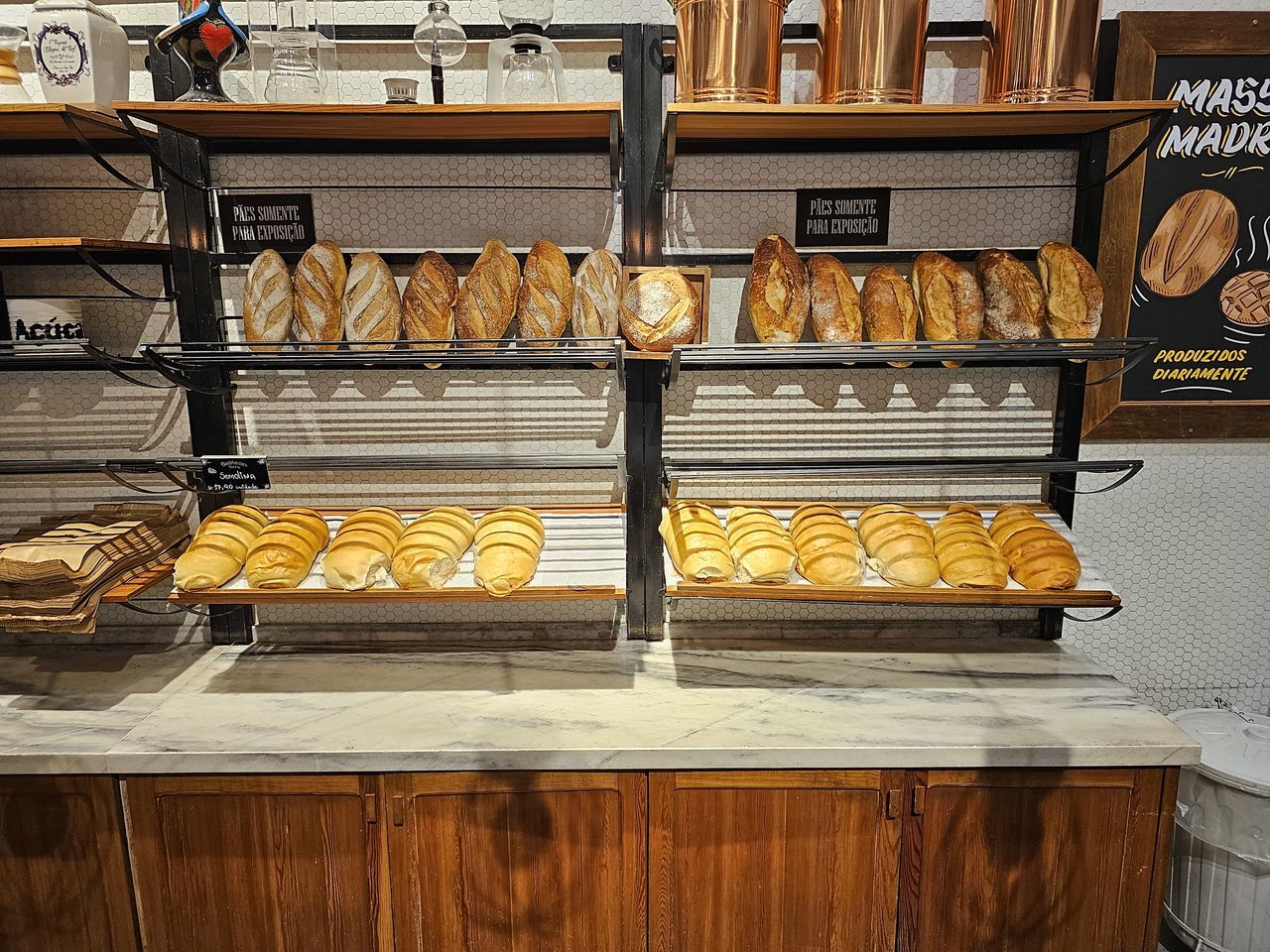 bakery, food and drink, food, store, shelf, no people, indoors, freshness, baker, baked, wood, bread, retail, business, variation, large group of objects, meal, arrangement, in a row, abundance, fast food