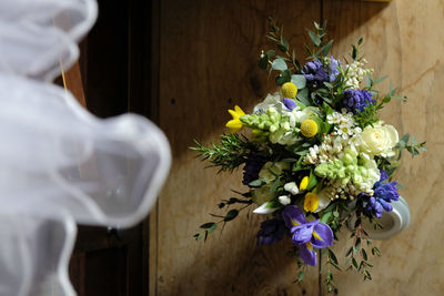 Close-up of wedding bouquet on wooden floor