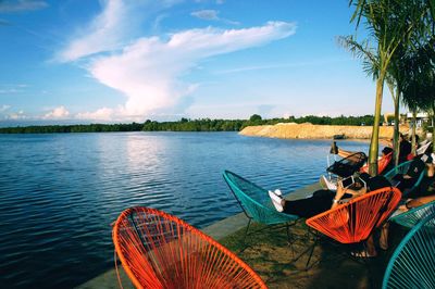 Boats moored in lake against sky