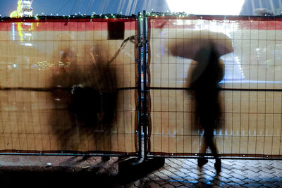 Blurred motion of man standing on tiled floor