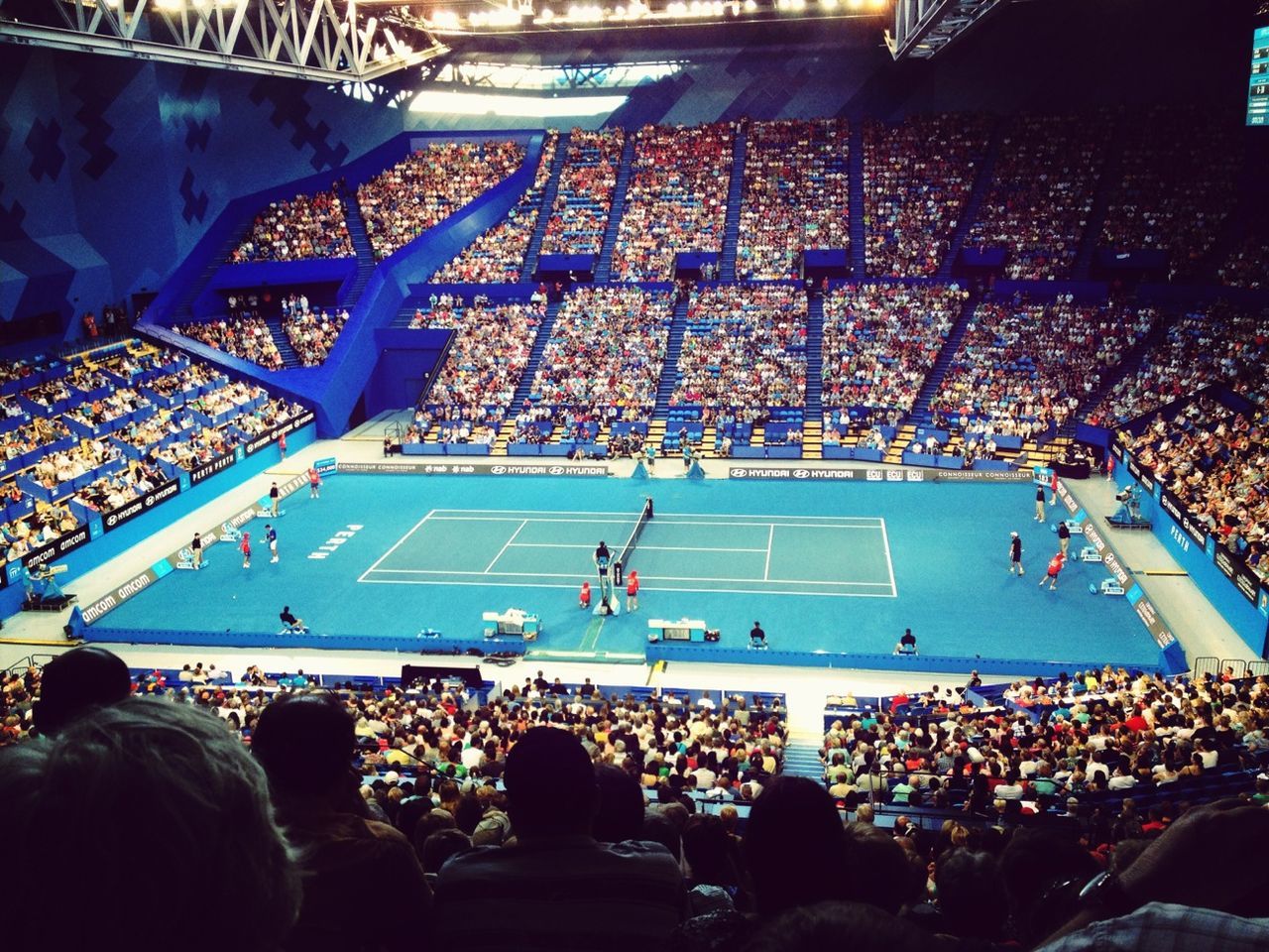 large group of people, men, crowd, person, lifestyles, leisure activity, high angle view, illuminated, indoors, mixed age range, crowded, stadium, city life, togetherness, sitting, standing, travel, spectator