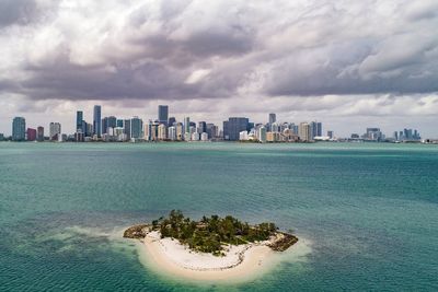 Scenic view of sea and buildings against sky