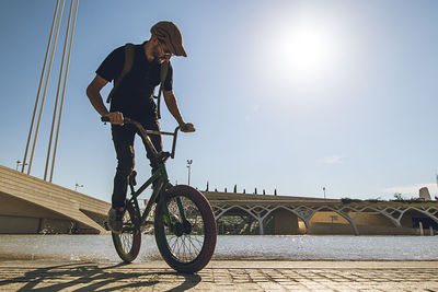 Man performing stunt on bicycle in city 