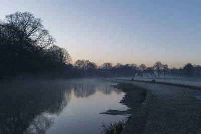 Scenic view of lake against clear sky during winter