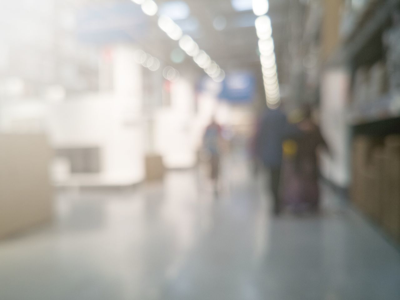 DEFOCUSED IMAGE OF PEOPLE WALKING ON ILLUMINATED STREET LIGHT