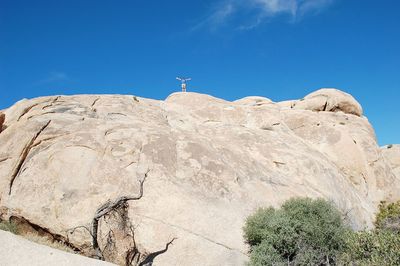 Low angle view of mountain against blue sky