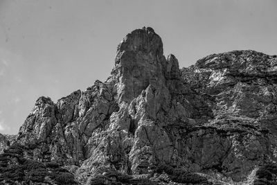 Low angle view of rock formation against sky
