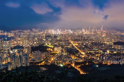 Illuminated cityscape against sky at night