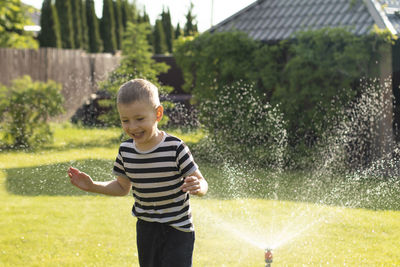 Portrait of boy standing on field