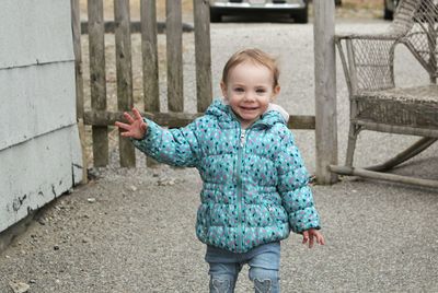 Portrait of smiling girl standing outdoors