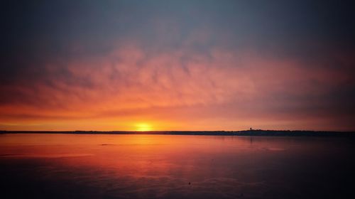 Scenic view of sea against romantic sky at sunset